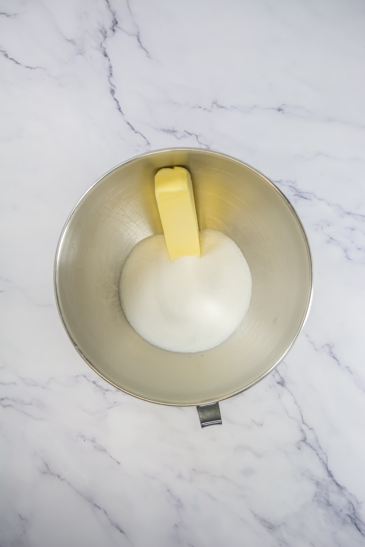 Butter and sugar in a bowl.