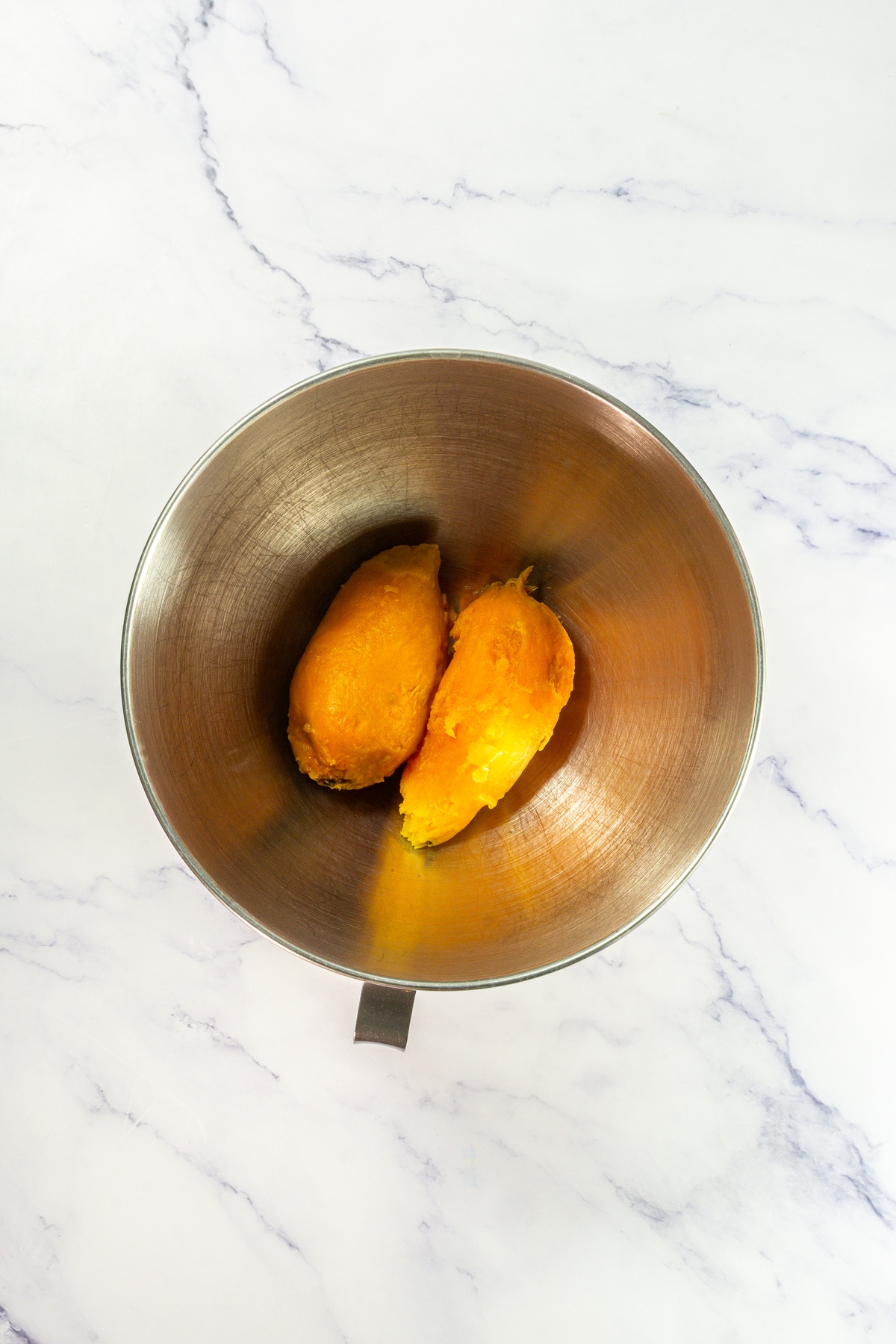 Skinned sweet potatoes in a pot.