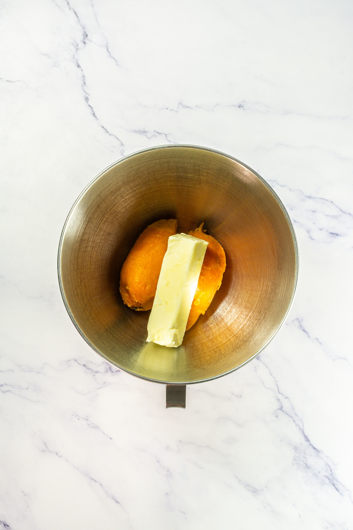 Sweet potatoes with butter in a bowl.