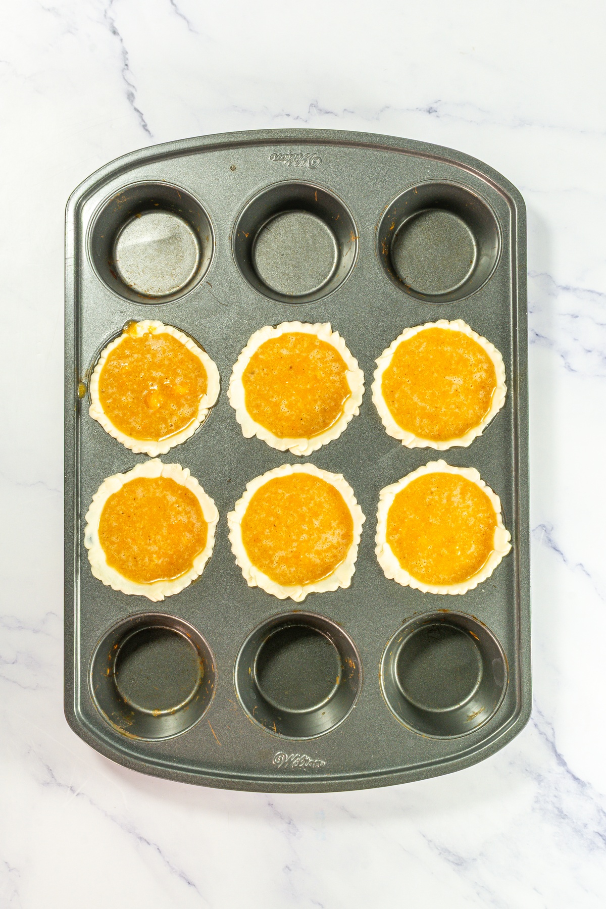 Pie crusts filled with sweet potato filling.